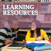 Two teens talking in library