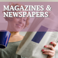 Woman reading newspaper while drinking coffee